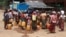 FILE - This photo taken on April 29, 2024, shows Kayah people gathering at a delivery of drinking water by the charity Clean Yangon at a camp for internally displaced people in Demoso township, in Myanmar's eastern Kayah state.