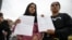 Women hold letters from the US embassy after their visa appointments was cancelled in Bogota on Jan. 27, 2025. 