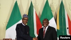 Nigeria's President Muhammadu Buhari shakes hands with his South African counterpart Cyril Ramaphosa during a news conference after a meeting, in Pretoria, South Africa, Oct. 3, 2019.
