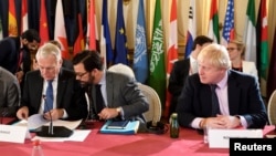 FILE - Britain's Foreign Secretary Boris Johnson (R) and French Foreign Minister Jean-Marc Ayrault (L) attend a ministerial summit to hold discussion on the future of Mosul city, post-Islamic State, in Paris, France, Oct. 20, 2016.