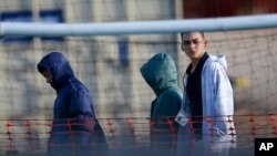Migrant teens walk inside the Tornillo detention camp in Tornillo, Texas, Thursday, Dec. 13, 2018.