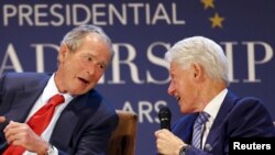 Former U.S. Presidents George W. Bush (L) and Bill Clinton share a laugh during a moderated conversation at the graduation of the inaugural class of the Presidential Leadership Scholars program, a partnership between the presidential centers of George W. 