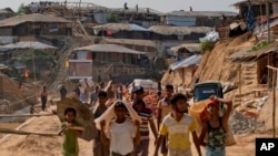 Rohingya refugees rebuild their makeshift houses, in preparation for the approaching monsoon season at the Kutupalong Rohingya refugee camp in Kutupalong, Bangladesh, April 28, 2018. Rohingya refugees who fled Myanmar during a brutal crackdown now face a new danger: rain. The annual monsoon will soon sweep through camps where some 700,000 Rohingya Muslims live in huts made of bamboo and plastic built along steep hills.