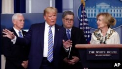 FILE - Shoppers practice social distancing as they wait in line to purchase produce at the Alemany Farmer's Market in San Francisco, California, March 21, 2020.
