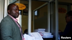 FILE - Tinomudaishe Chinyoka, one of the lawyers representing ZANU PF's Presidential candidate Emmerson Mnangagwa, arrives to file opposing papers at the Constitutional Court in Harare, Zimbabwe, Aug. 15, 2018.
