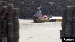Members of the Muslim Brotherhood and supporters of deposed Egyptian President Mohamed Morsi rest amongst bricks stacked throughout their camp in the Nasr City area, east of Cairo Aug. 11, 2013.