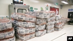 FILE - Packages of cocaine sit at a facility in Sydney, Australia, in this undated photo provided by Australian Federal Police on Jan. 18, 2018. Police said June 4, 2021, that they foiled a plan to bring nearly three tons of cocaine into Australia.