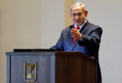 FILE - Israeli Prime Minister Benjamin Netanyahu gestures as he speaks during a news conference at the State House, in Entebbe, Uganda, Feb. 3, 2020.