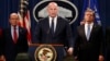 Acting Attorney General Matt Whitaker, center, with Commerce Secretary Wilbur Ross, left, and FBI Director Christopher Wray speak, Jan. 28, 2019, at the Justice Department in Washington. 