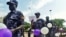 Ugandan police hold balloons and signs condemning violence against women, Kampala, Uganda, Dec. 5, 2015.