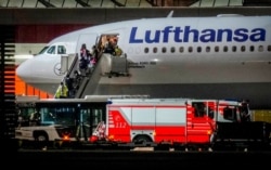 FILE - People disembark from a Lufthansa aircraft coming from Tashkent in Uzbekistan that landed at the airport in Frankfurt, Germany, Aug. 18, 2021. On board were about 130 people that were evacuated from Afghanistan.