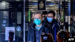 FILE - Hong Kong law professor and pro-democracy activist Benny Tai gestures outside Ma On Shan Police station following his release on bail in Hong Kong, Jan. 7, 2021.