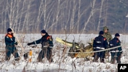 Personnel work at the scene of the AN-148 plane crash near Stepanovskoye, about 40 kilometers (25 miles) from the Domodedovo airport, Russia, Feb. 12, 2018. The plane carrying 71 people crashed Sunday near Moscow, killing everyone aboard.