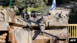An Israeli army Merkava main battle tank is deployed by the concrete border wall at a position along Israel's northern border with Lebanon, Feb. 18, 2025.