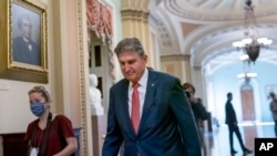 Sen. Joe Manchin, D-W.Va., walks to a caucus lunch at the Capitol in Washington, Dec. 17, 2021. 