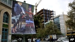 A poster depicting an American negotiator wearing a suit jacket and tie at a negotiating table and a dog to his side is displayed in Palestine square, Tehran, Iran, Oct. 27, 2013.