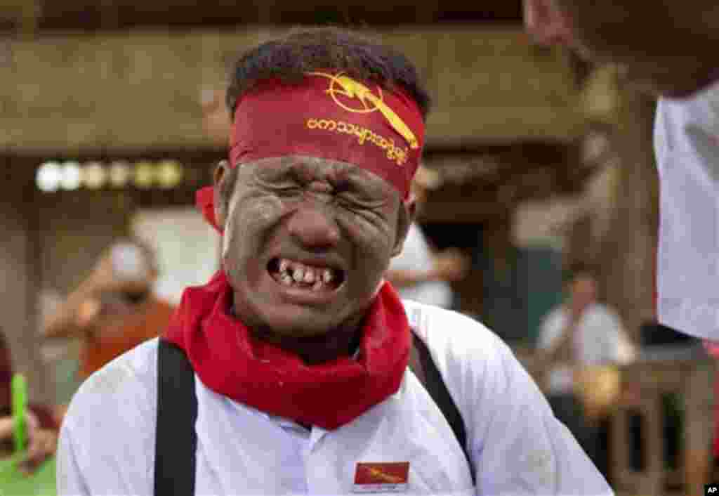 A student protester grimaces as a paramedic treats an injury he sustained while struggling with police during a protest in Letpadan, March 10, 2015.