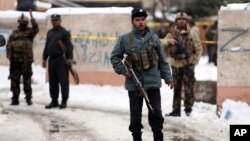 Security personnel stand guard at the site of a suicide attack on the Supreme Court in Kabul, Afghanistan, Feb. 7, 2017. 