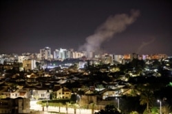 Smoke rises over houses in Ashkelon following a rocket attack launched from Gaza toward Ashkelon, southern Israel, May 14, 2021.