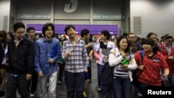 In this 2013 photo, students leave after a college entrance test at AsiaWorld-Expo in Hong Kong.