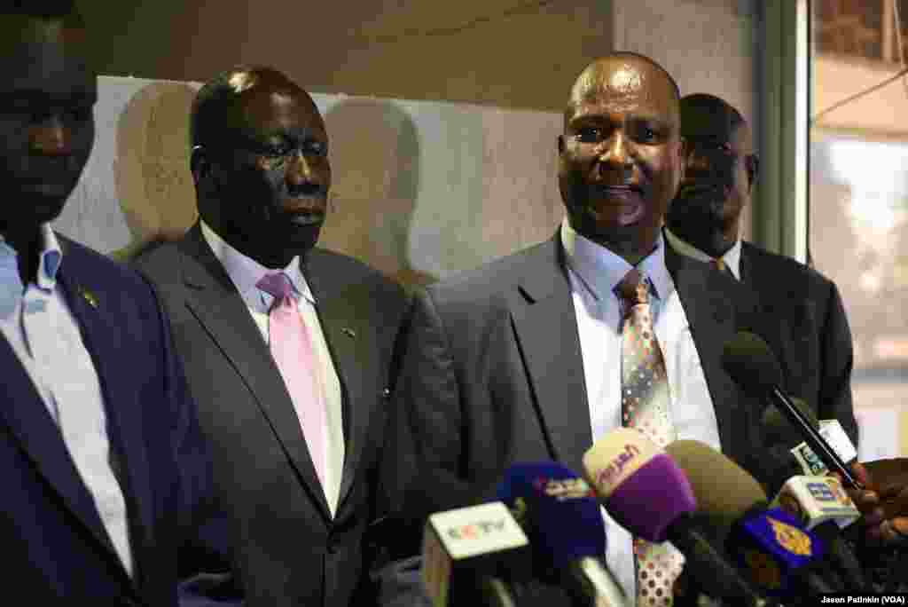 Taban Deng Gai, right, chief negotiator for South Sudan's rebels, speaks at a news conference following the arrival of the rebels' second-in-command, Alfred Lado Gore, center left, in Juba, April 12, 2016.