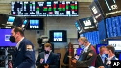 FILE - Traders work on the floor of the New York Stock Exchange, May 18, 2021. Investors remain focused on the possibility for more inflation later this year. (NYSE photo)