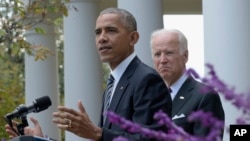 President Barack Obama, accompanied by Vice President Joe Biden, speaks about the election results in the Rose Garden at the White House in Washington, Nov. 9, 2016.