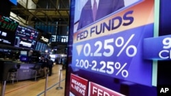 A television monitor on the floor of the New York Stock Exchange headlines the rate decision of the Federal Reserve, July 31, 2019.
