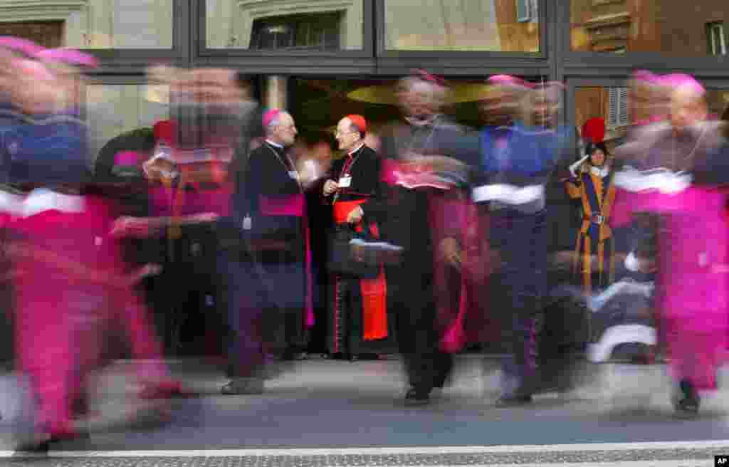 Cardinals and bishops leave at the end of a morning session of the Synod of bishops, at the Vatican in Rome.