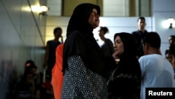 FILE - Relatives of victims of human trafficking wait for the sentence after an army general, two provincial politicians and police officers were among the 46 people held guilty in a court in Bangkok, Thailand, July 19, 2017.