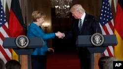 President Donald Trump and German Chancellor Angela Merkel shake hands at a joint news conference in the East Room of the White House in Washington, March 17, 2017.