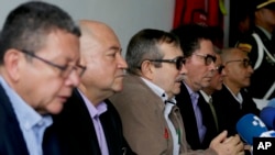 Former top leader rebel Rodrigo Londono, and fellow former FARC commanders, hold a press conference after appearing before a special peace tribunal in Bogota, Colombia, Sept. 23, 2019. 