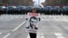 Protesters wearing yellow vests walk on the Champs-Elysees Avenue with the Arc de Triomphe in the background during a national day of protest by the "yellow vests" movement in Paris, Dec. 8, 2018.