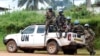 FILE - Blue-helmeted members of the U.N. Organization Stabilization Mission in the Democratic Republic of Congo sit on the back of a pickup truck in Beni, Oct. 23, 2014.
