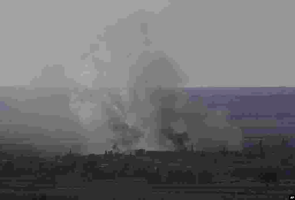 Smoke from fires are seen during fighting between Syrian Kurds and the Islamic State militants, as seen from the Turkey-Syria border, Oct. 21, 2014.