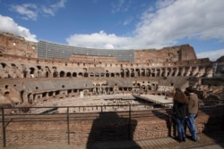 Tourists visit the Colosseum, in Rome, March 7, 2020. With the coronavirus emergency deepening in Europe, Italy, a focal point in the contagion, risks falling back into recession as foreign tourists are spooked from visiting its cultural treasures.