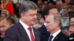Ukraine's President-elect Petro Poroshenko, left, walks past Russian President Vladimir Putin during the 70th anniversary commemoration of D-Day in Ouistreham, western France, June 6, 2014.