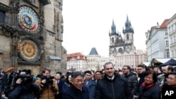 FILE - Prague Mayor Zdenek Hrib and Taipei Mayor Ko Wen-je shake hands before signing a partnership pact in Prague, Jan. 13, 2020. China has threatened action against Czech companies in China if Czech senators go ahead with a planned visit to Taiwan.