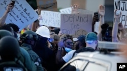 A protester yells during protests Saturday, June 13, 2020, near the Atlanta Wendy's where Rayshard Brooks was shot and killed by police Friday evening following a struggle in the restaurant's drive-thru line in Atlanta.