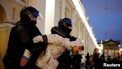 A demonstrator is taken away by law enforcement officers during a rally in support of jailed Russian opposition politician Alexei Navalny in Saint Petersburg, Russia April 21, 2021.