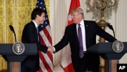 FILE - U.S. President Donald Trump, right, shakes hands with Canadian Prime Minister Justin Trudeau during their joint news conference in the East Room of the White House, Feb. 13, 2017, in Washington.
