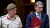 Britain's Defense Secretary Philip Hammond, right, and the Chief of Defense Staff Gen. Nick Houghton leave 10 Downing street following a national security meeting at Dow ning Street in London, Aug. 28, 2013.