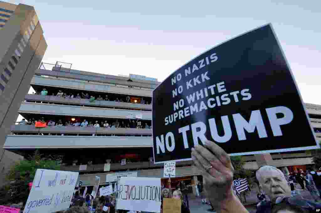 People protest outside the Phoenix Convention Center, Aug. 22, 2017, in Phoenix. Protests were held against President Trump as he hosted a rally inside the convention center.