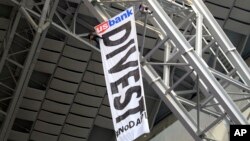 Protesters against the Dakota Access Pipeline rappel from the catwalk in U.S. Bank Stadium during the first half of an NFL football game between the Minnesota Vikings and the Chicago Bears, Jan. 1, 2017, in Minneapolis. 