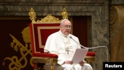 Newly elected Pope Francis I, Cardinal Jorge Mario Bergoglio of Argentina, meets cardinals in the Clementine Hall in a picture released by Osservatore Romano at the Vatican, March 15, 2013. 