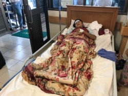 Un Neng, 16, recovers from her injuries and nearly 24 hours in a collapsed building in Sihanoukville, Cambodia, June 22, 2019. She was among the 26 to survive. Her parents were among the 28 killed. (VOA/A. Chhengpor)
