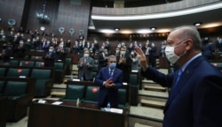 Turkey's President Recep Tayyip Erdogan arrives to address the lawmakers of his ruling party at the parliament, in Ankara, Turkey, Nov. 11, 2020.