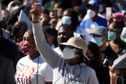 FILE - Demonstrators rally to protest the shooting of Ahmaud Arbery, in Brunswick, Georgia, May 8, 2020.
