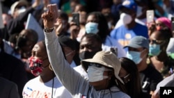 FILE - Demonstrators rally to protest the shooting of Ahmaud Arbery, in Brunswick, Georgia, May 8, 2020. 