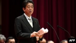 Japan's Prime Minister Shinzo Abe delivers a speech during the graduation ceremony of the National Defense Academy in Yokosuka, Kanagawa prefecture, Japan, March 18, 2018.